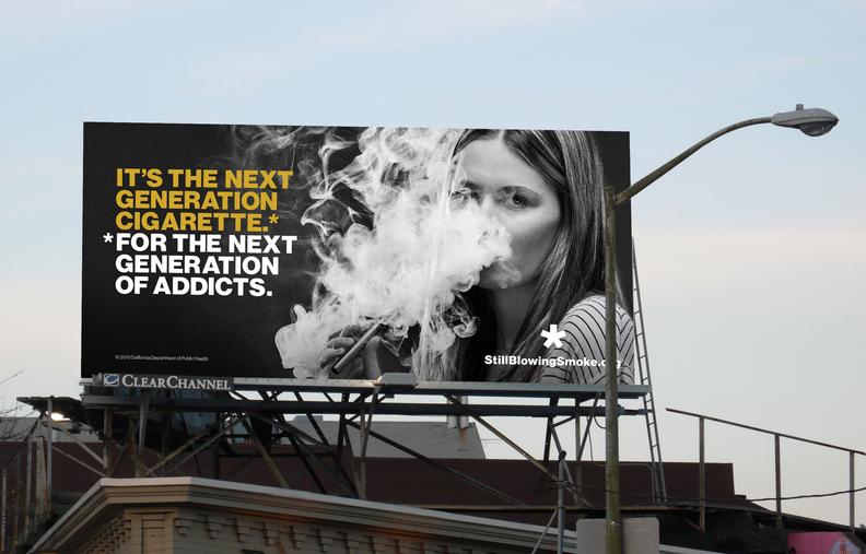An anti-smoking billboard showing a young girl blowing a cloud of smoke with an e-cigarette in her hand.