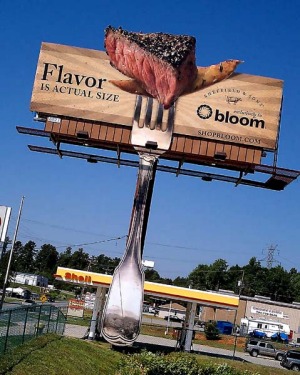Scented billboard shows a juicy steak and a golden french fry.